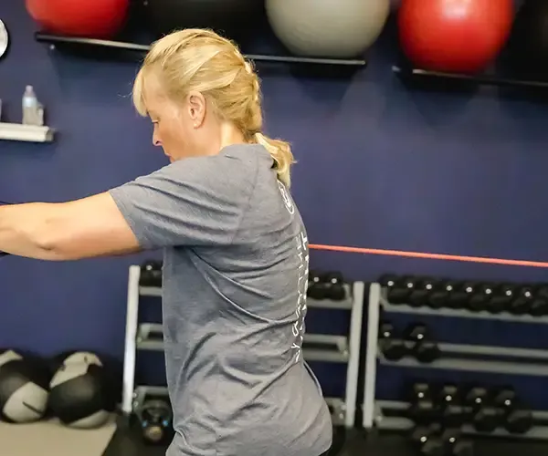 Woman performing core exercise in a 50+ fitness class