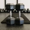 Two Dumbells in front of a fitness mat